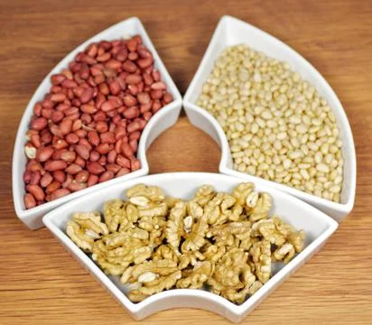 Walnuts, peanut and pine nut Stock Photos