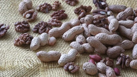 Walnuts, peanuts on yelow background. Video stock 83639059