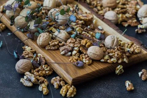 Walnuts peeled and in shell on the table. Healthy nutrition, vegetarianism, d Stock Photos