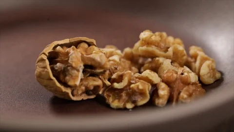 Walnuts peeled lie in pan Still Closeup Stock Footage 99165657