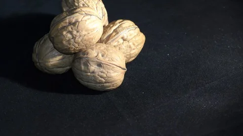 Walnuts in pile are rotating on wheel with shadow Video stock 111274243