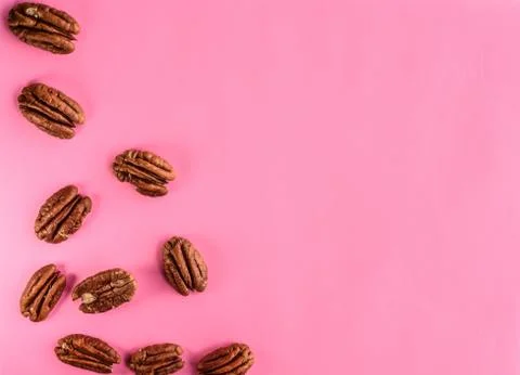 Walnuts on pink background, empty space Stock Photos