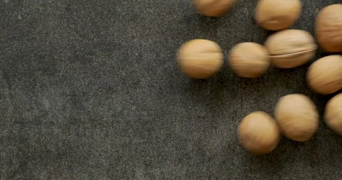 Walnuts pour on the stone table Stock Footage 113447759