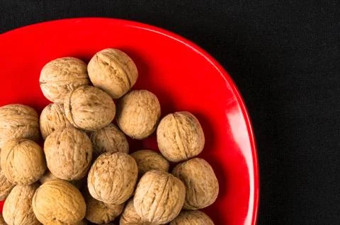 Walnuts in red plate Stock Photos