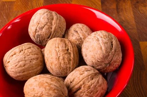 Walnuts in red plate Stock Photos