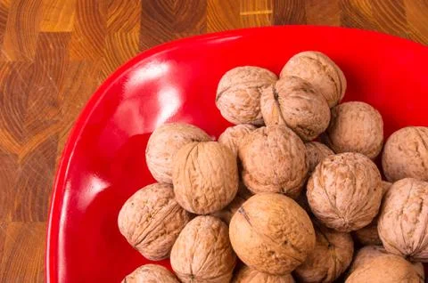 Walnuts in red plate Stock Photos
