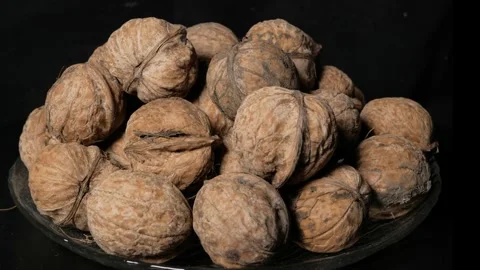 Walnuts rotating on black background, Close-up. Stock Footage 297875732