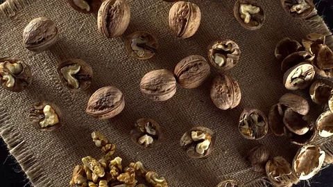 Walnuts in rotation on sackcloth background Stock Footage 71356306