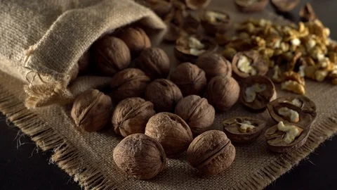 Walnuts in rotation on sackcloth background Stock Footage 71357477