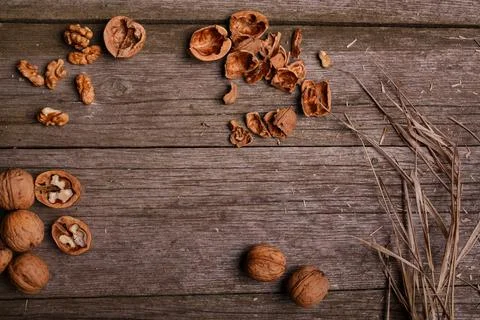 Walnuts on rustic background wooden board with straw copy space for text Stock Photos