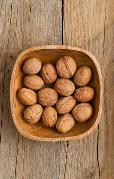 Walnuts in rustic bowl Stock Photos