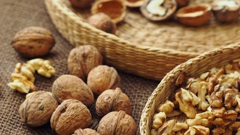 Walnuts on rustic natural burlap, Walnut kernels in wicker basket. Stock Footage 121470298