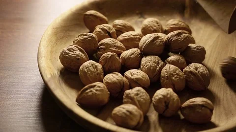 Walnuts on rustic old wooden table Stock Footage 74704429