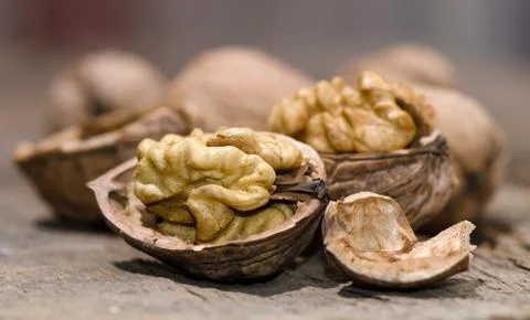 Walnuts on rustic old wooden table Stock Photos