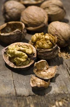 Walnuts on rustic old wooden table Stock Photos