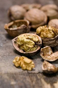 Walnuts on rustic old wooden table Stock Photos