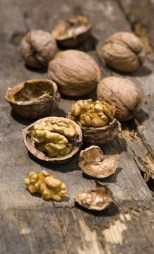 Walnuts on rustic old wooden table Stock Photos