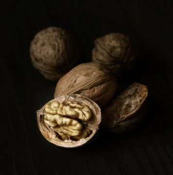Walnuts on rustic old wooden table Stock Photos
