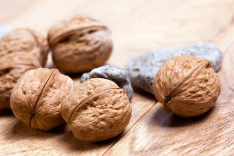 Walnuts on rustic wooden board Stock Photos
