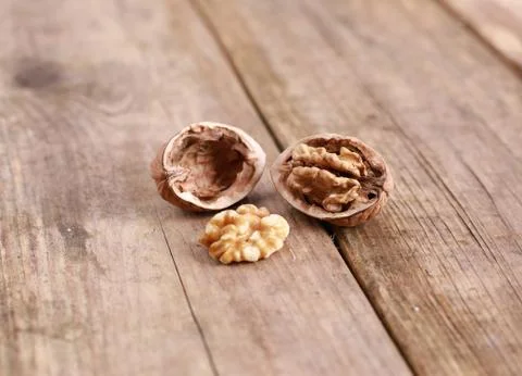 Walnuts on a rustic wooden table - close up Stock Photos