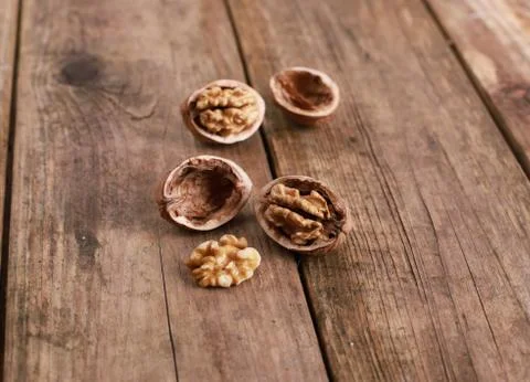 Walnuts on a rustic wooden table - close up Stock Photos