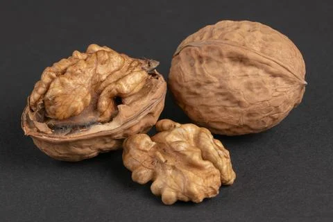 Walnuts scattered on a dark background, macro 写真素材