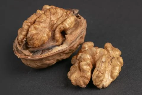 Walnuts scattered on a dark background, macro Stock Photos