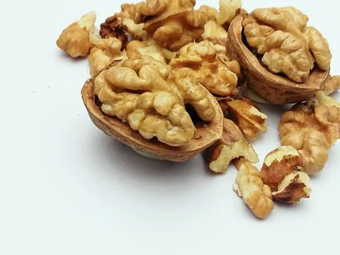 Walnuts in shell and walnut kernels isolated on white background Stock Photos