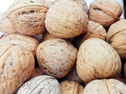 Walnuts in shell close up background Stock Photos