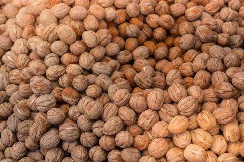 Walnuts in shell heap pattern as organic food background Stock Photos