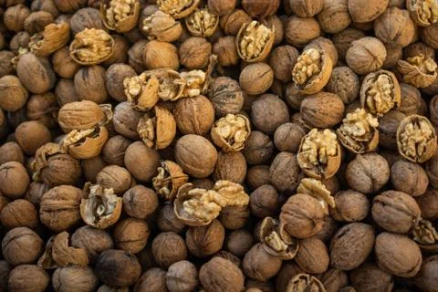 Walnuts in shell heap pattern as organic food background Stock Photos