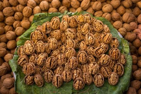 Walnuts in shell heap pattern as organic food background Stock Photos