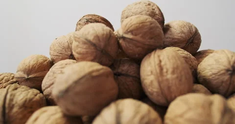 Walnuts shells in heap, stop motion, side view. Pile of nuts Rotation, seamless Stock Footage 281922680