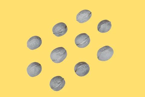 Walnuts in shells lie in rows. Creative food pattern in trendy colors 2021, y Stock Photos