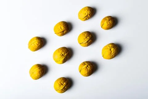 Walnuts in shells lie in rows. Creative food pattern in trendy colors 2021, y Foto stock