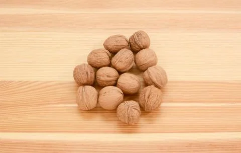Walnuts in shells on wood Stock Photos