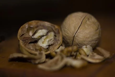 Walnuts with shells on a wooden table Stock Photos