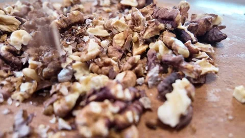 Walnuts slow motion video. Whole walnut pieces falling onto white table top.. Stock Footage 301871673