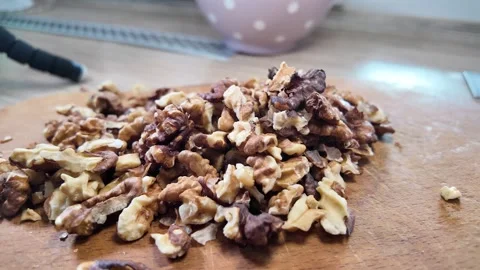 Walnuts slow motion video. Whole walnut pieces falling onto white table top.. Stock Footage 301871689