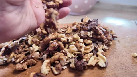 Walnuts slow motion video. Whole walnut pieces falling onto white table top.. Stock Footage 301871690