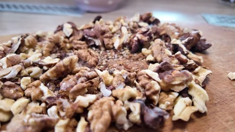 Walnuts slow motion video. Whole walnut pieces falling onto white table top.. Stock Footage 301871718