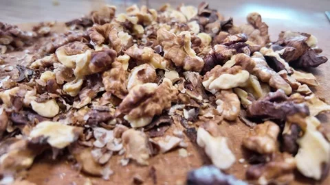 Walnuts slow motion video. Whole walnut pieces falling onto white table top.. Stock Footage 301871767