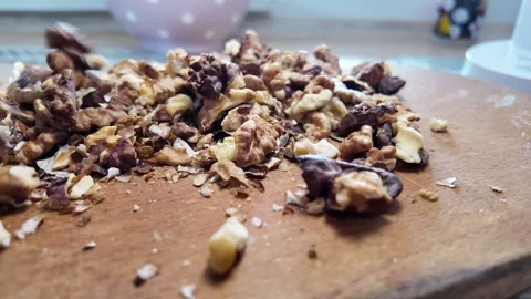 Walnuts slow motion video. Whole walnut pieces falling onto white table top.. Stock Footage 301871770