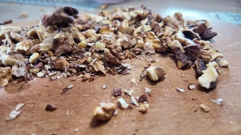 Walnuts slow motion video. Whole walnut pieces falling onto white table top.. Stock Footage 301871777