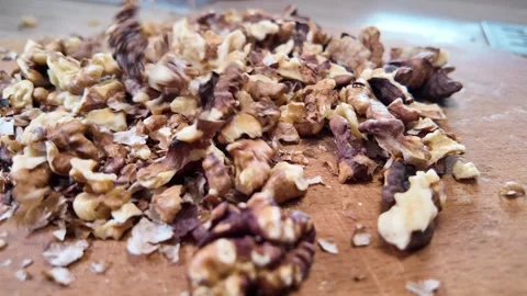Walnuts slow motion video. Whole walnut pieces falling onto white table top.. Stock Footage 301871861