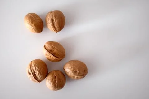 Walnuts spilled on a white table Stock Photos