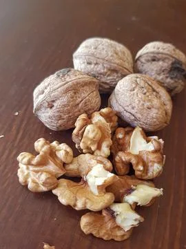 Walnuts in their shells and without them Stock Photos