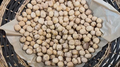 Walnuts in their shells in a woven basket, with natural organic nuts  Stock-Footage 331331989