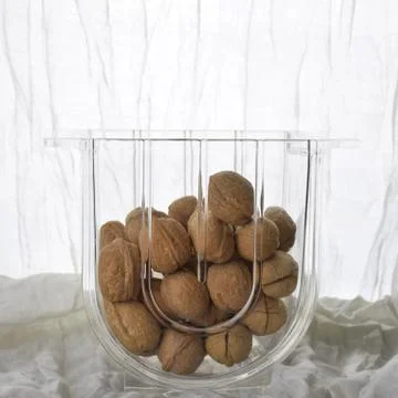 Walnuts in the transparent glass vase Stock Photos