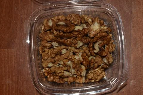 Walnuts in a transparent plastic box  Stock Photos
